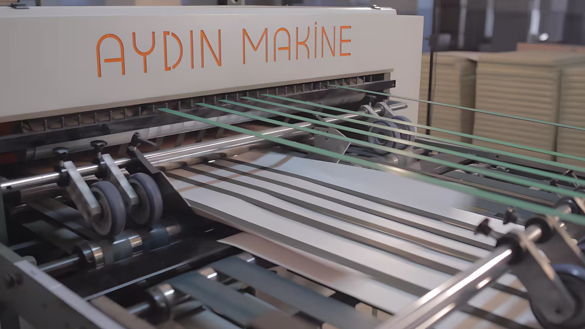 Adjustable stacker and band conveyor system of paper sheeter machine